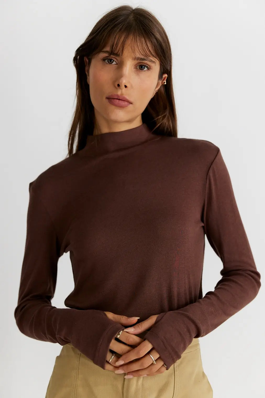The most essential basic of your winter wardrobe is a good long sleeve to layer underneath warm winter coats. This mock neck long sleeve top is spun from a soft cotton blend that is lightweight and easy to wear. Thumb slits in sleeves to secure sleeves in place. Style yours tucked into any bottoms or with a layered look.