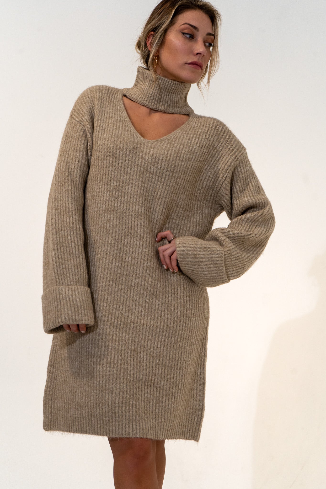 Featuring a relaxed fit, The Kate Sweater Dress is an effortlessly cool design that pairs well with just about everything, while our favorite way to style is with tights and your favorite pair of boots. Mock neck with a V-style cut out on chest. Oversized cuffed sleeves. Quality ribbed material, slightly brushed. 