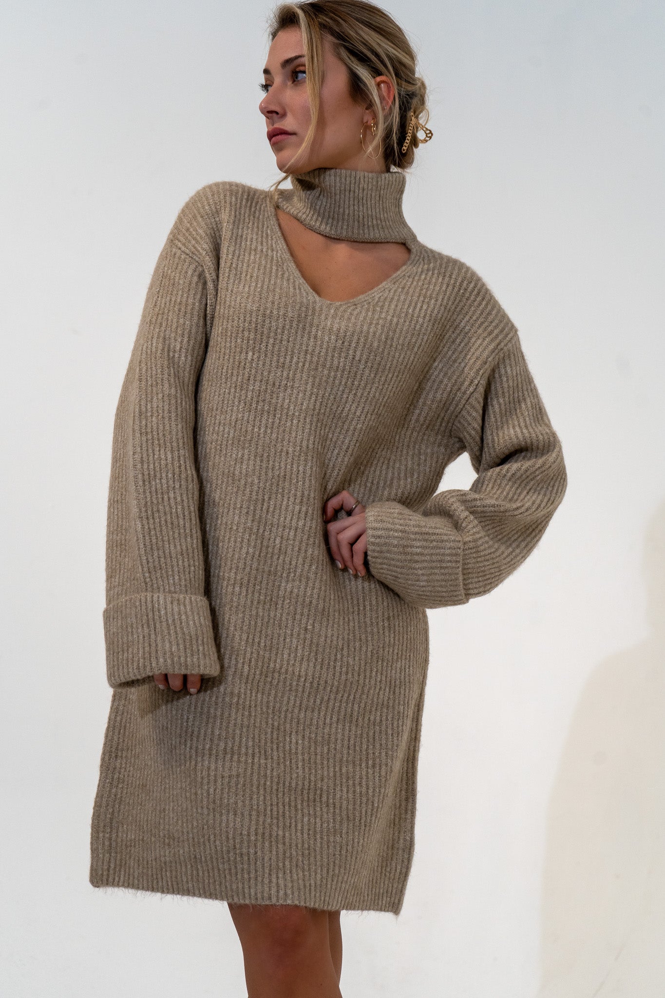 Featuring a relaxed fit, The Kate Sweater Dress is an effortlessly cool design that pairs well with just about everything, while our favorite way to style is with tights and your favorite pair of boots. Mock neck with a V-style cut out on chest. Oversized cuffed sleeves. Quality ribbed material, slightly brushed. 